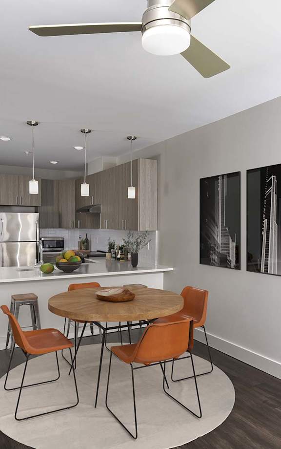 A modern kitchen with a dining table and chairs.