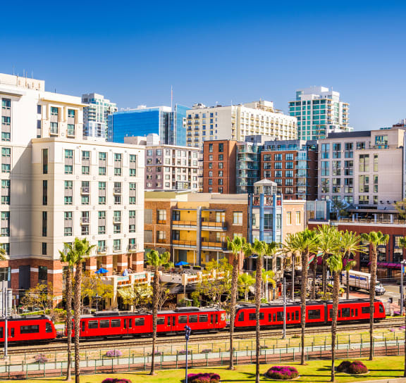 a red train traveling through the city of san diego  at VORA LUX, San Diego, CA 92120