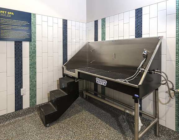 A Pet Spa machine is in a room with a sign on the wall.