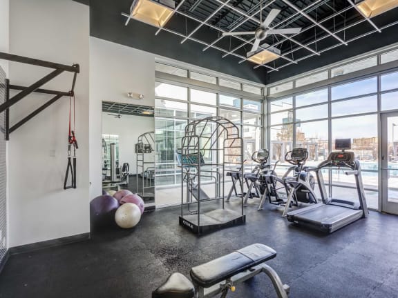 a workout room with exercise equipment at the bradley braddock road station apartments
