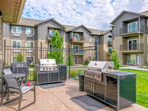 the preserve at ballantyne commons community patio with two bbq grills and chairs