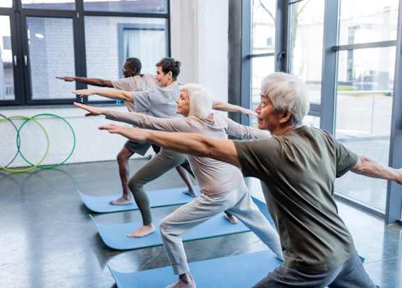A group of people practicing yoga in a studio.