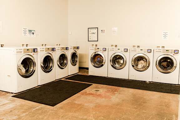 A row of washing machines in a laundromat.
