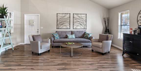 A living room with a grey couch and a coffee table.