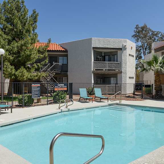 A pool area with chairs and a fountain at Cohea Archibalds.