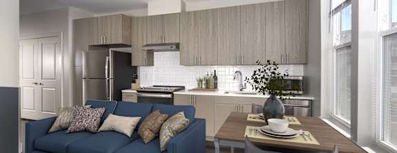 A modern kitchen with a blue couch and a dining table.