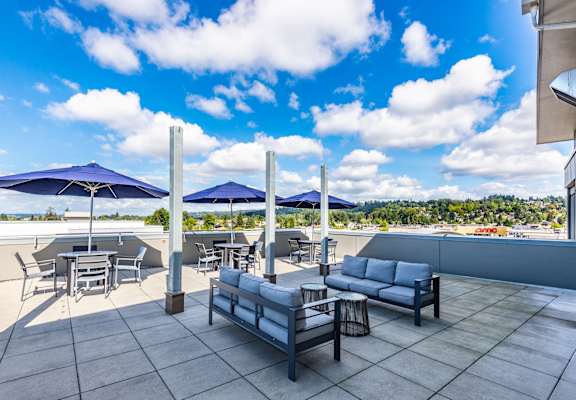 A modern outdoor seating area with a view of the sky.