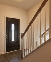 a view of a door from the bottom of a staircase