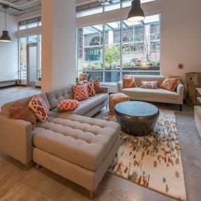 a living room with couches and a coffee table in front of a large window