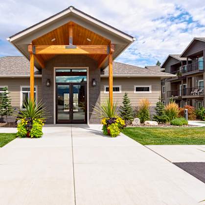 a home with a large glass door and a wooden roof