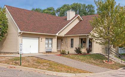 A house with a brown roof and a white garage door.