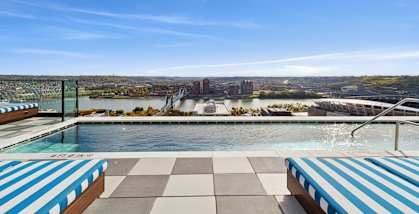 A pool with a view of a city skyline.