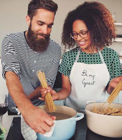 a man and two women making pasta in a kitchen at Cypress Creek at River Oaks, Waxahachie, TX