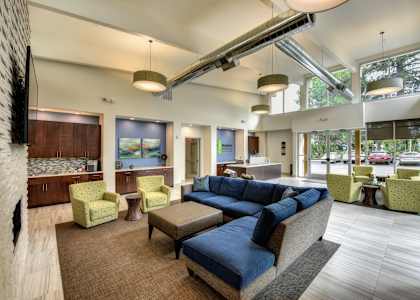 a large living room with a blue couch and chairs