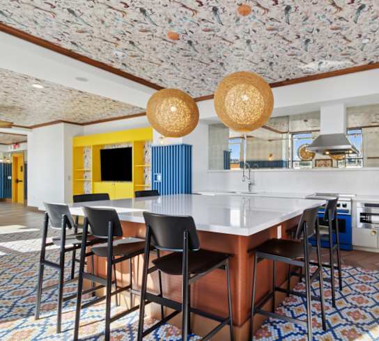 A kitchen with a table and chairs in the middle of the room.