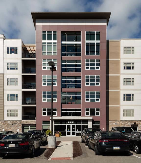 A parking lot with cars in front of apartment buildings. at Cosmopolitan Apartments, Pennsylvania, 15237