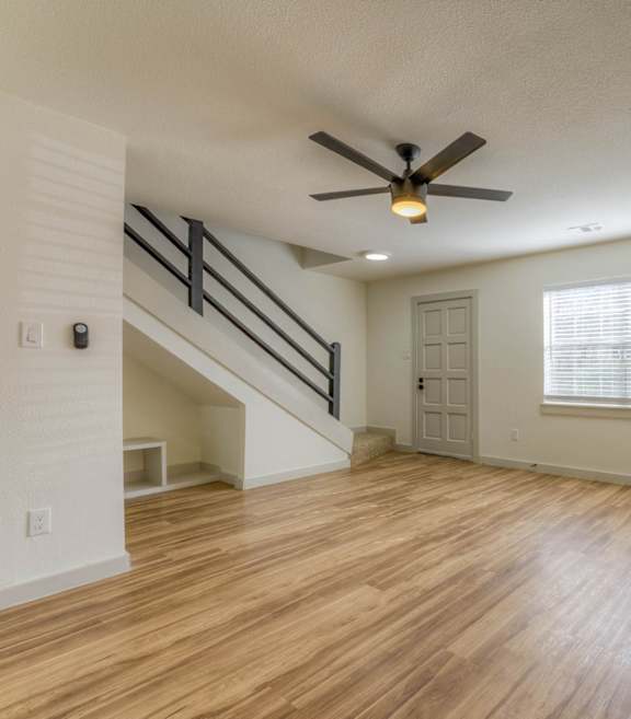 A room with a wooden floor and a ceiling fan.at The Garden District Apartments, Tennessee, 38138