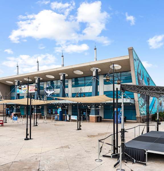 A stage is set up in front of a building with a blue and white exterior. at Monmouth Row Apartments, Newport, 41071