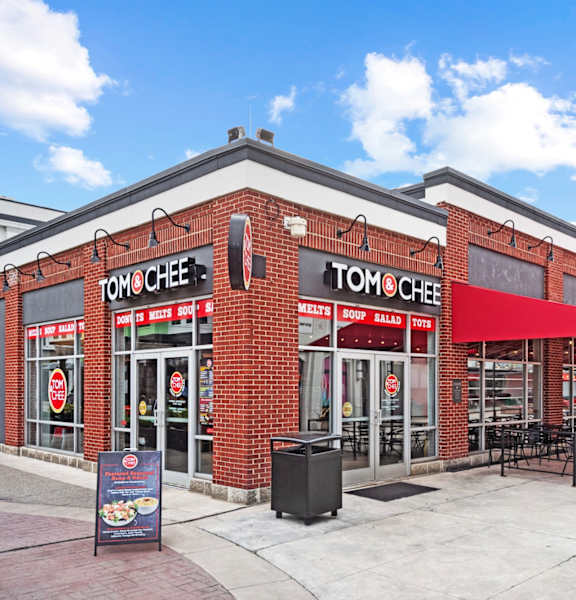 a brick restaurant with a red awning at Monmouth Row Apartments, Newport, KY, 41071