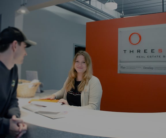 two people sitting at a table at a desk