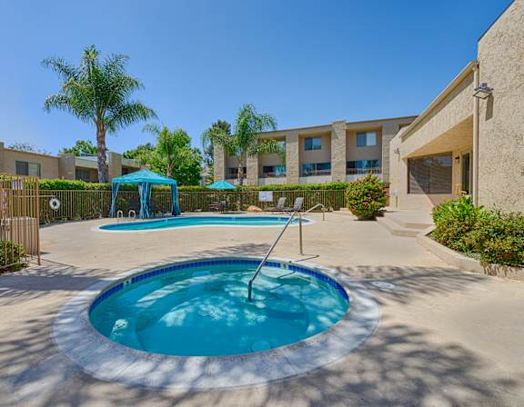 A small pool with a ladder in the middle of it.