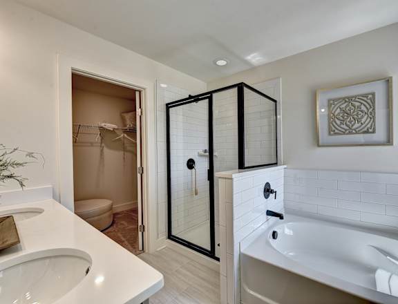 a bathroom with a tub and a shower and a sink