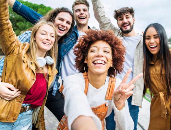 A group of friends are taking a selfie together.