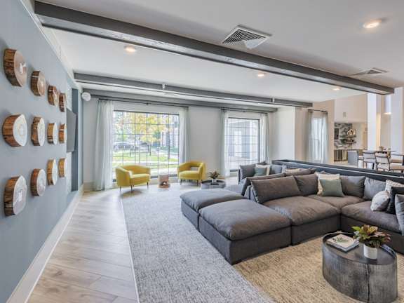 A modern living room with a grey sofa and yellow chairs.