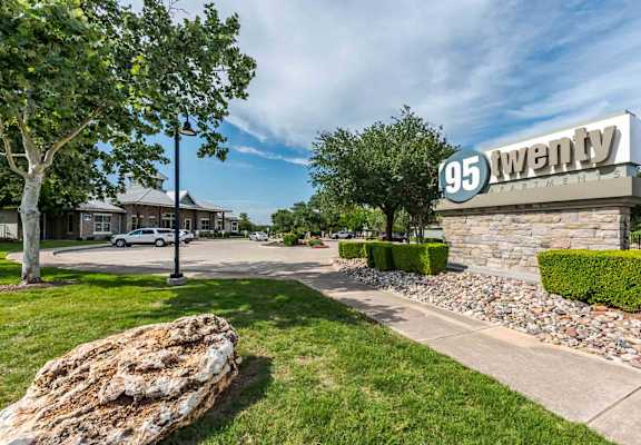 A sign that says 95 Twenty in front of a building.