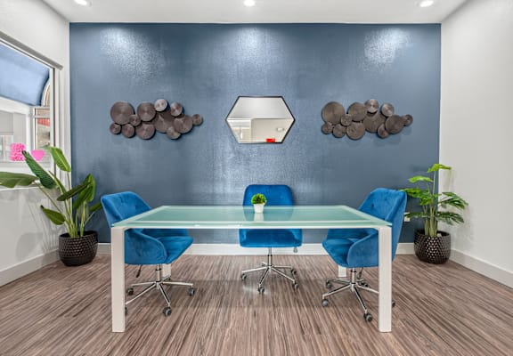 a conference room with blue chairs and a glass table at Collective on Riverside, Austin, 78741