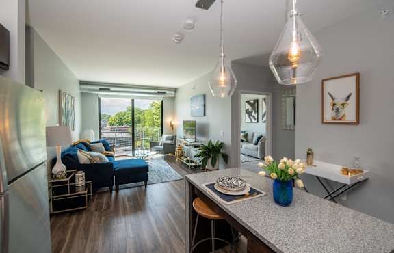 a living room with a kitchen and a dining table at Soll, Des Moines, 50312