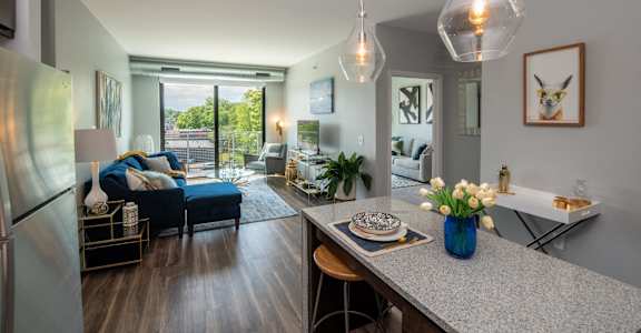 a living room with a kitchen and a dining table at Soll, Des Moines Iowa