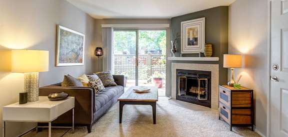 a living room with a couch and a fireplace