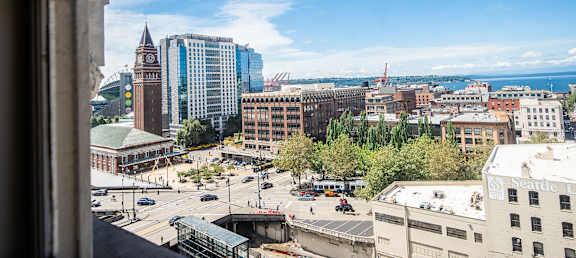 A cityscape with a clock tower and a clear blue sky.
