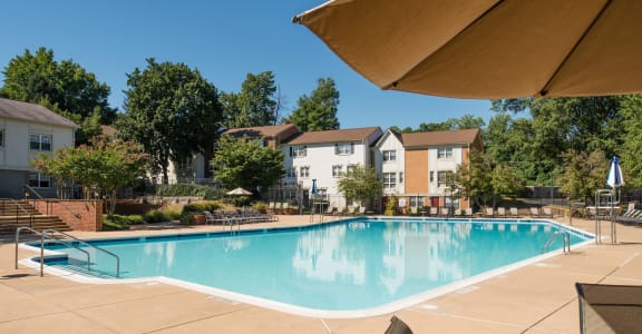 Invigorating Swimming Pool of Amberleigh apartments and townhomes with walkways and surrounded by trees and greenery in Fairfax, Virginia 22031