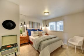 Bedroom with Window with Wood Frame Bed, Carpet, Record Player and Window