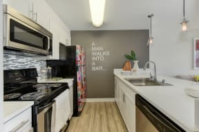 Kitchen with Hardwood Inspired Floor, Oven, Stove and Cabinets