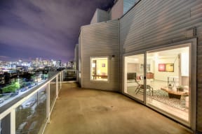 Private Balcony at Night with View of Living Room and Street