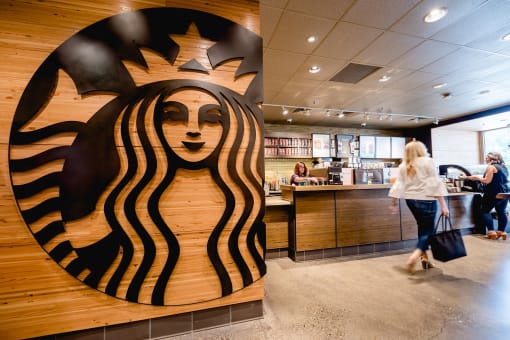 a logo for starbucks is shown on the wall of a coffee shop