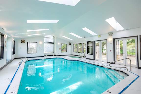A large indoor swimming pool with a blue line on the side.
