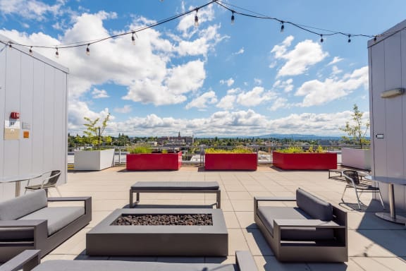 a terrace with couches and tables on a sunny day