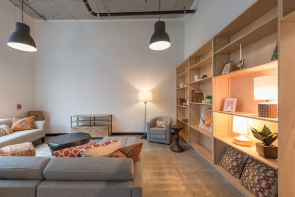 a living room filled with furniture and a large bookshelf