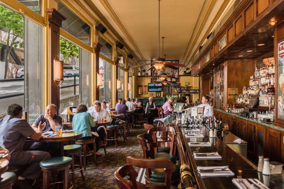 people sitting at a bar in a restaurant