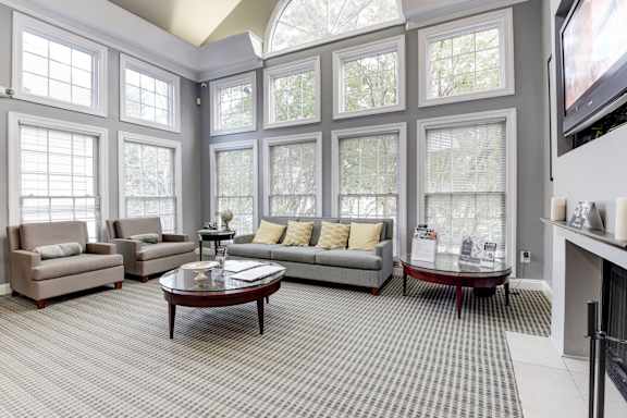 A living room with a grey couch, a coffee table, and a television.