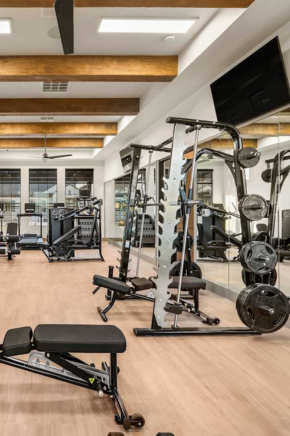 A woman is running on a treadmill in a gym.