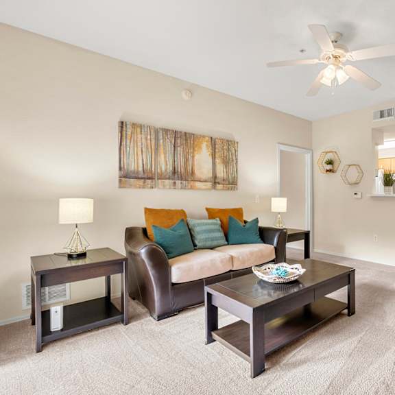 A living room with a brown sofa and a coffee table.