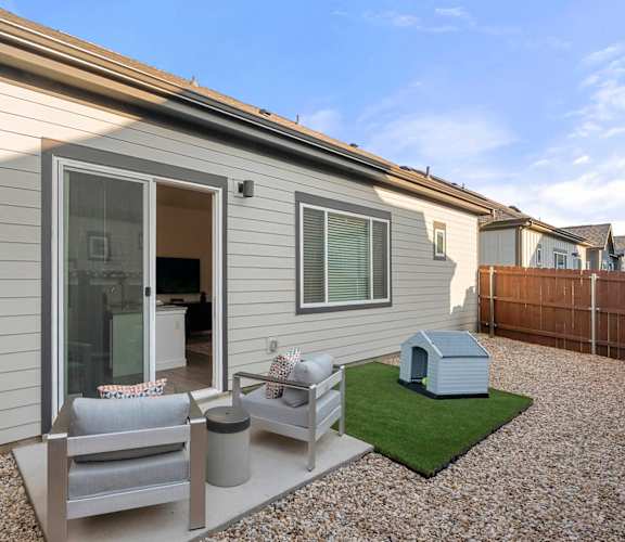 A small house with a patio and a small garden.