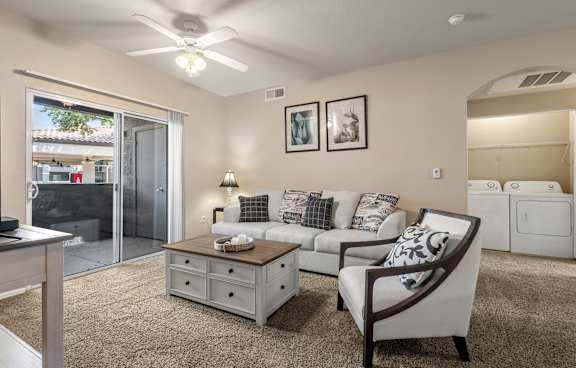 A living room with a couch, chair, and a table.
