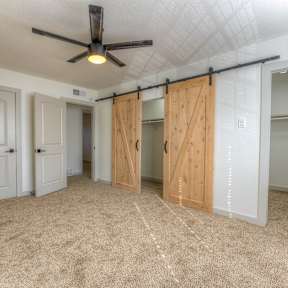 A room with a ceiling fan and sliding doors.at The Garden District Apartments, Tennessee, 38138