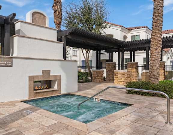 A pool with a hot tub and a sign that says "POOLS 11pm - 7am".